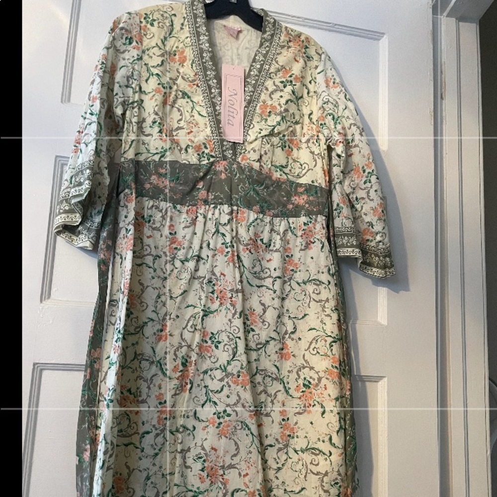 Dress in floral print with bell sleeves and tie back. By Nolita junior size L
